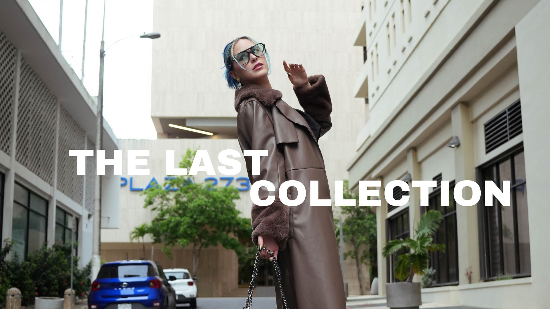 Woman in a long brown coat standing on a street